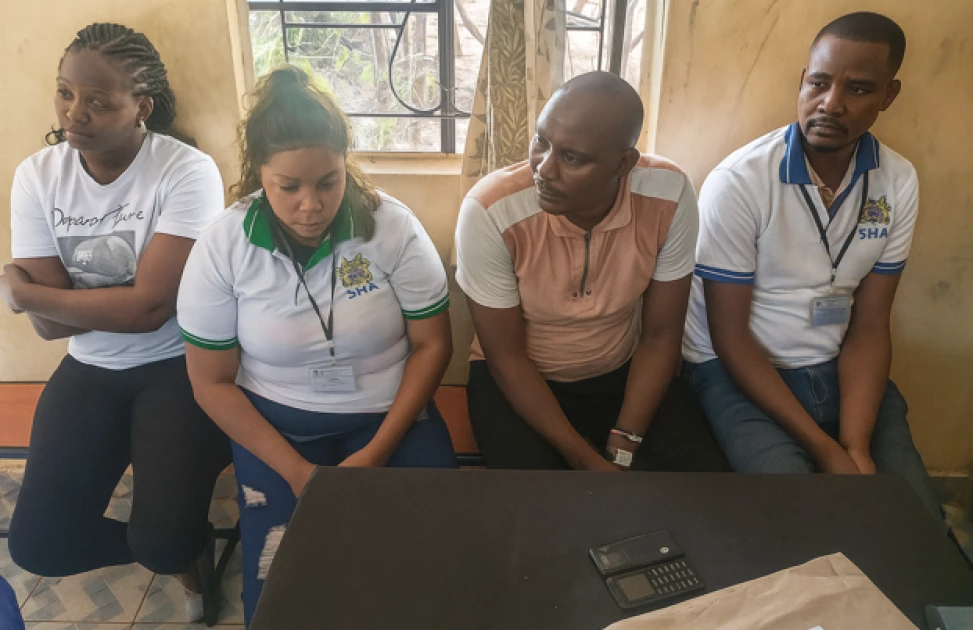 DCI detectives display fake SHA registration materials and Toyota Prado seized from fraud suspects in Marimanti.