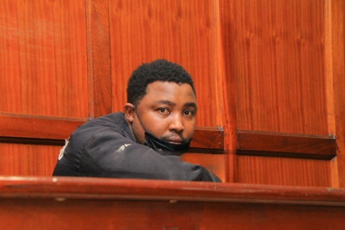 DCI officers escort suspect Robbisson Warui Mureithi to court over Sh74 million computer accessories theft investigation.