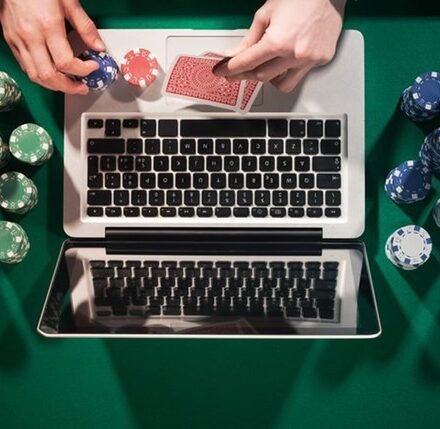 An image of a Person using a laptop to enjoy online gambling in Michigan