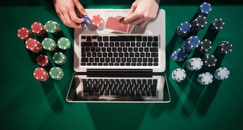 An image of a Person using a laptop to enjoy online gambling in Michigan